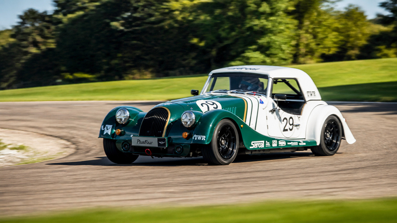 Carro esportivo clássico verde e branco com número 29 em pista de corrida ao ar livre.