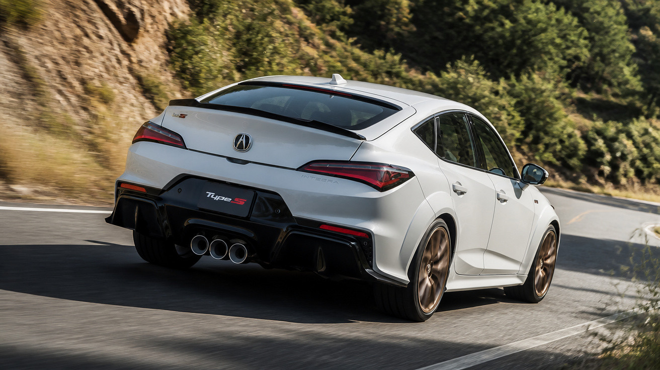 Carro esportivo branco Acura Type S em curva de estrada sinuosa com vegetação ao redor.